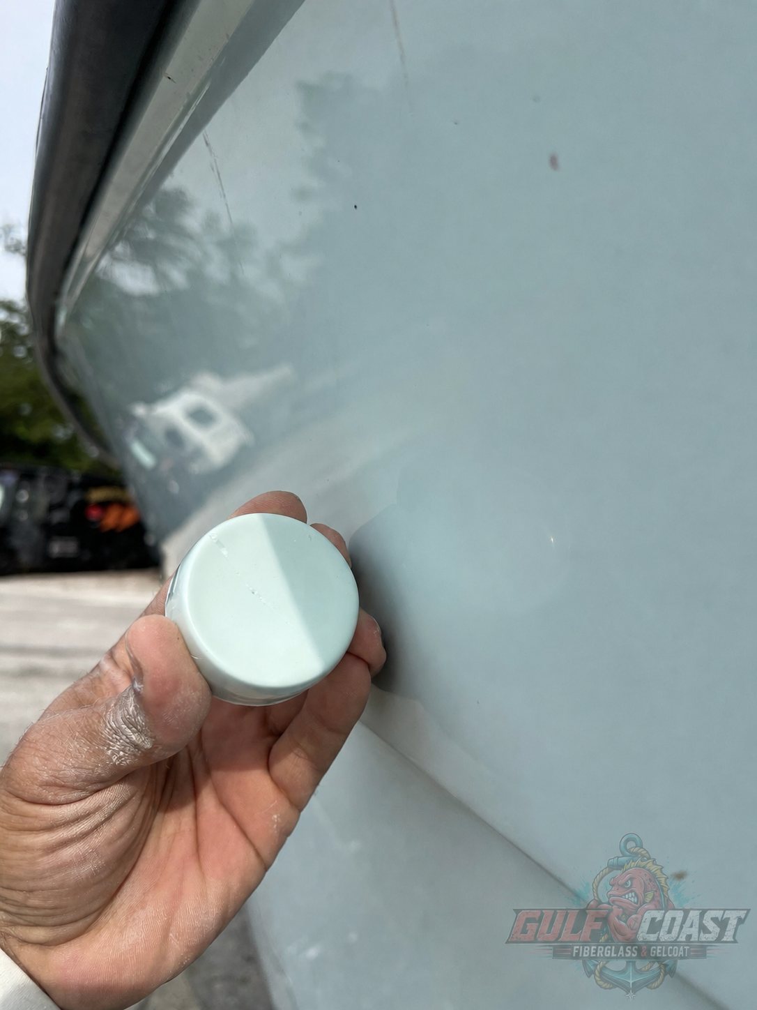 Gelcoat color sample held against the boat’s existing finish in daylight